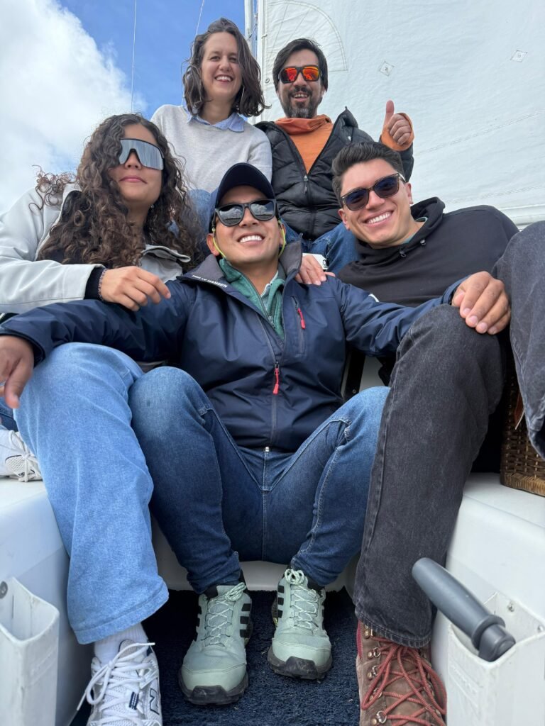 Group of friends smiling for a picture in a lake in Colombian Andes