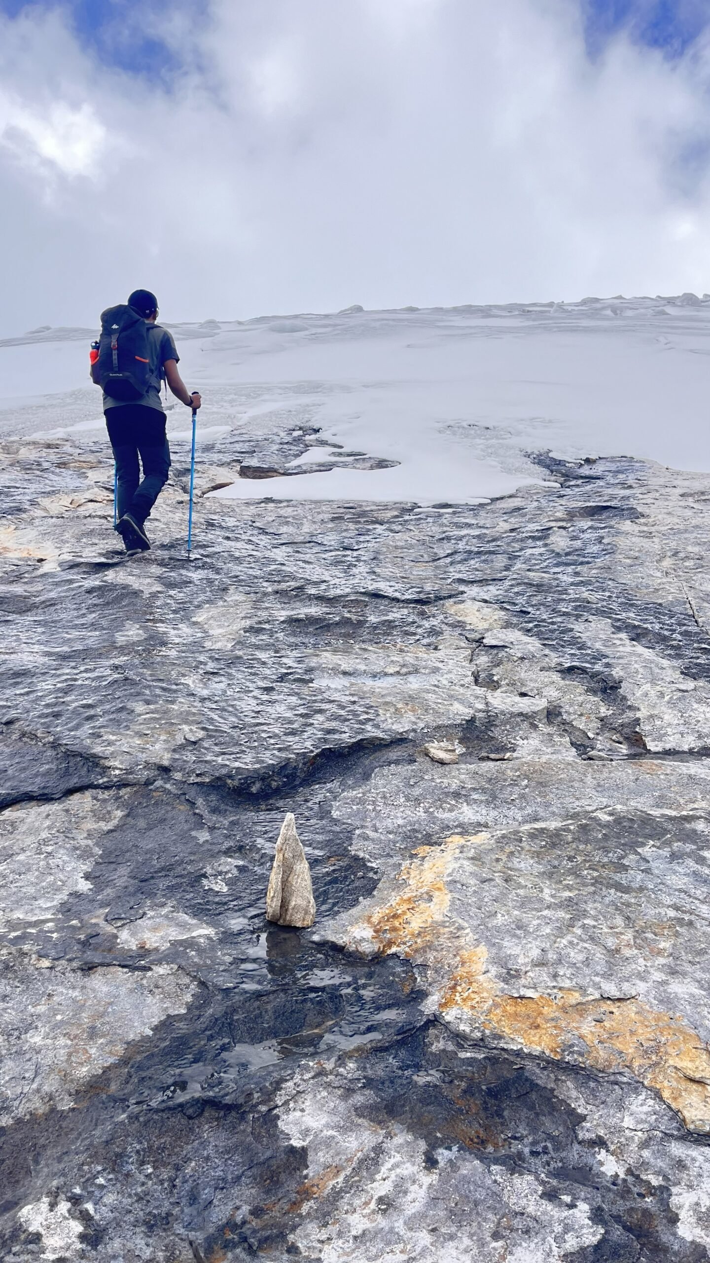 Hiker climbing toward ritacuba blanco in cocuy national park