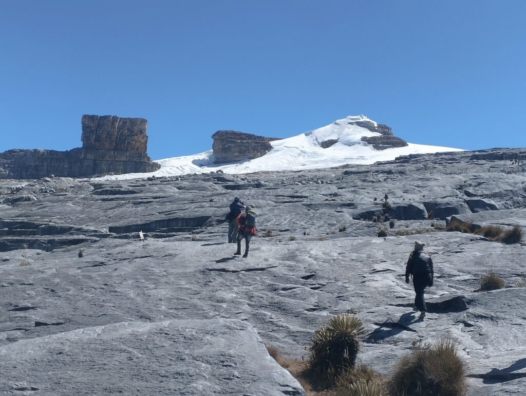 Hiker walking in a trail to the top of the Pan de Azucar glacier and Pulpito del Diablo
